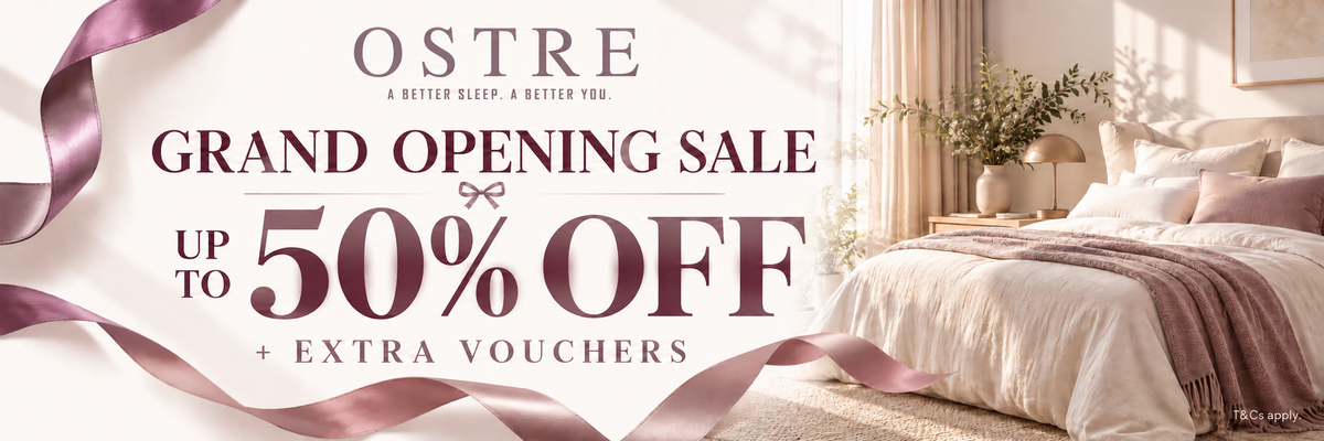 Promotional banner for Oestre featuring a beautifully styled bedroom with a bed, pillows, and curtains in the background, alongside large text advertising a grand opening sale with up to 50% off and extra vouchers.